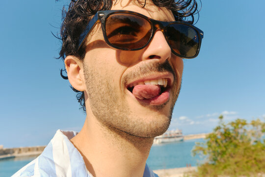 Man making a face and looking silly in the beach