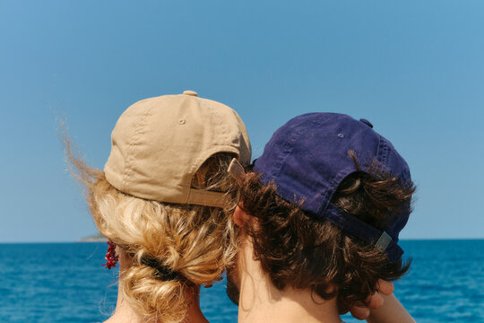 Romantic couple wearing caps with the ocean as background