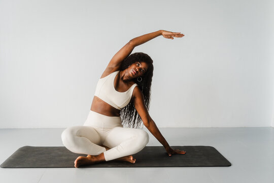 Woman stretches herself on the floor