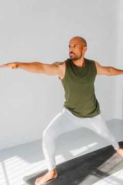 Man practicing yoga warrior pose