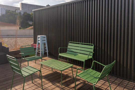 Seating Area With Green Chairs on a Rooftop Terrace in the City