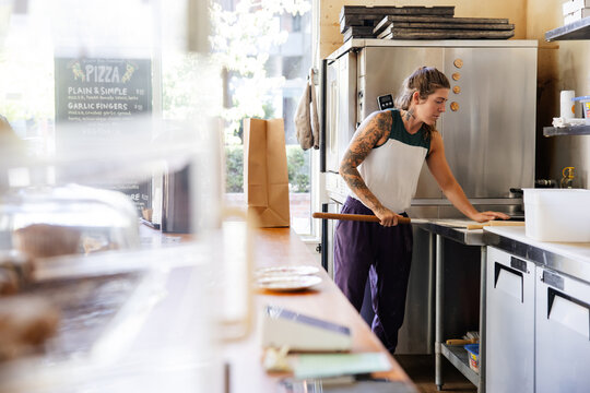 Woman working in a pizza shop