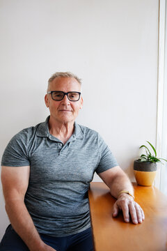 Man seating near indoor plant