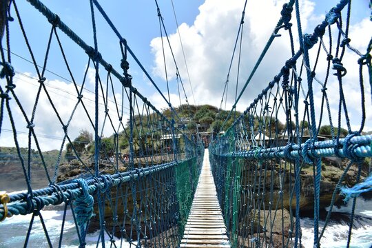 Beautiful view of the blue sea and blue sky of Timang beach in Yogyakarta, Indonesia. There is a suspension bridge to get to Timang Island.