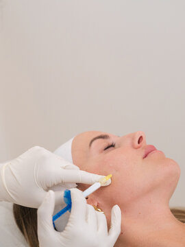 Woman receiving skin care facial injection cosmetic treatment