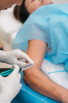 Medical professional injecting medicine into a patient's arm