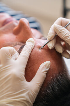 Beautician performing facial cleansing 