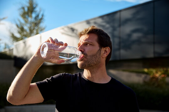 Trainer drinking water after exercise session