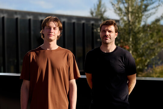 Two men standing outdoors after running session