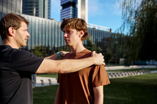 Trainer showing proper shoulder alignment outdoors