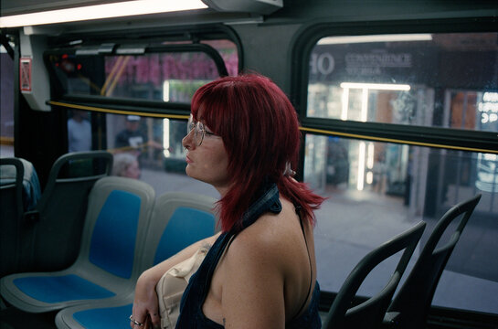 Potrait of a red haired woman on the bus.