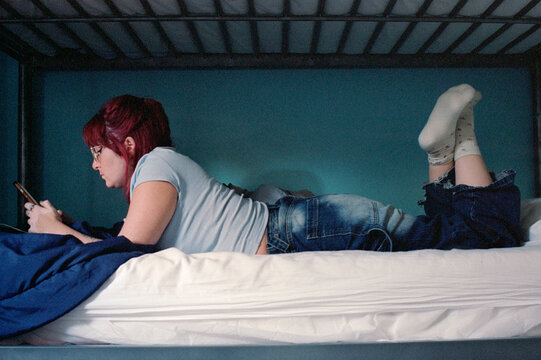 Using the phone on the bed.