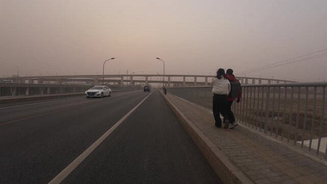 Pedestrians walking in strong sandstorm wind in Beijing China 1