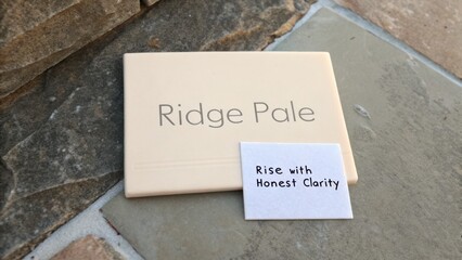 Elegant tile on natural stone surface with uplifting message promoting authenticity and clarity in design and decor