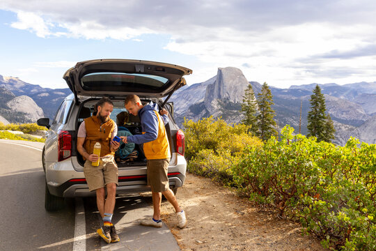 Hiker mobile phone with car Yosemite National Park 