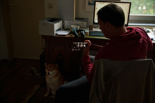 Playing Guitar at Home With Dog