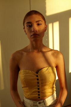 Portrait of a woman with very short shaved hair.