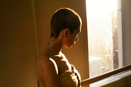 Portrait of a woman with very short shaved hair.