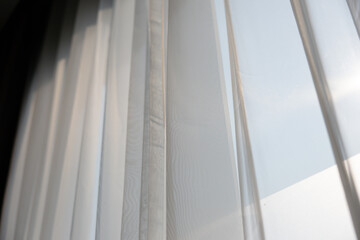 Obraz premium A window with white curtains that are drawn open