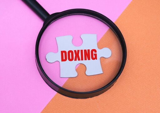The magnifying glass over the puzzle piece with the word DOXING 