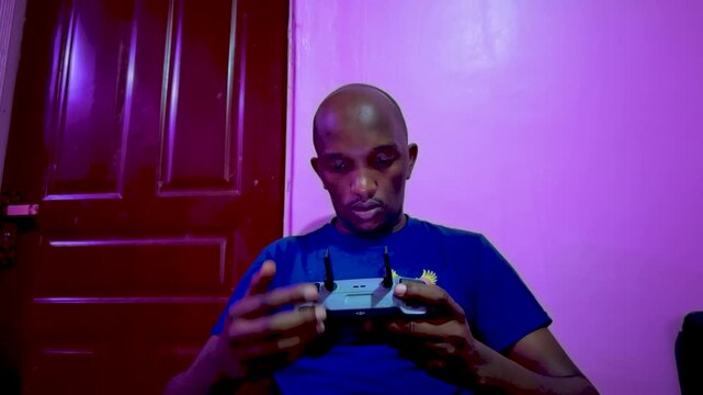 Africa black man operating drone- maasai man using drone