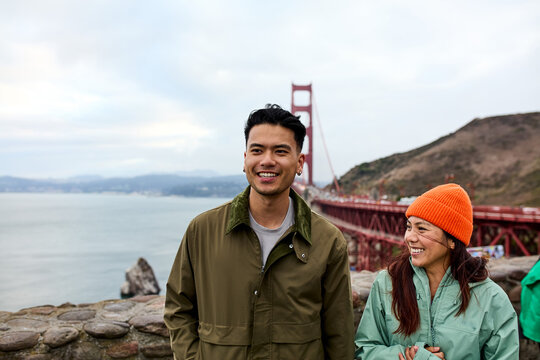 Smiling couple visits Golden Gate Bridge