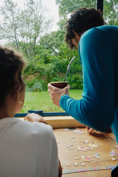 Mother and son enjoying time together solving a puzzle
