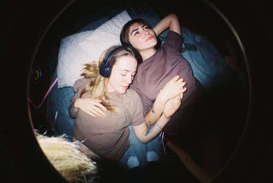 Shared Serenity: Couple Holding Hands in Dual Headphones