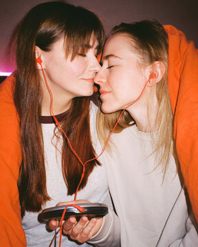 Noses Touching: Couple Sharing Music on Player