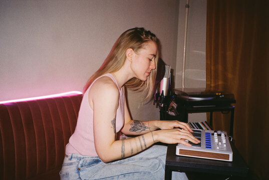 Side Portrait: Musician Composing on MIDI Keyboard