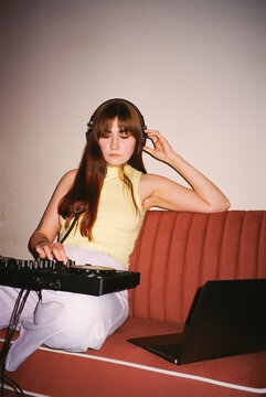 Portrait of a DJ Curating Her Set At Home Studio 