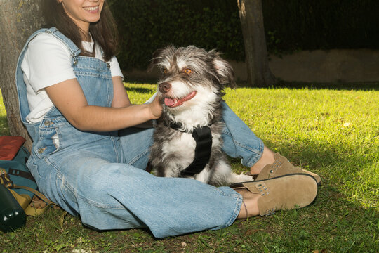 Woman enjoying time with her dog in a sunny park