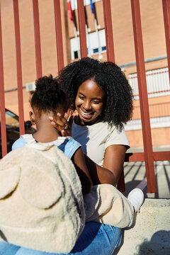 Mother hugging daughter before school drop-off