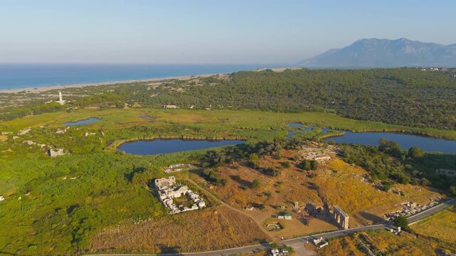 Gelemis, Turkey. Panoramic view of Patara ancient city with gate, road, Hurmalik Hamami at Tepecik, beach and mediterranean sea. Aerial View