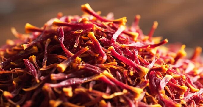 Close-up of vibrant red saffron threads piled together, showcasing their texture and color