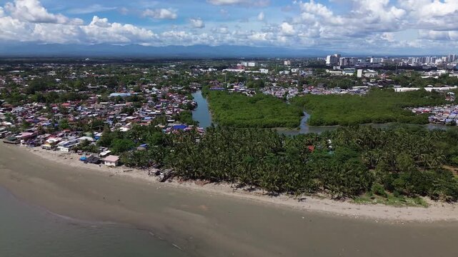 Drone aerial of Iloilo City highlighting modern skyline, residential districts, Rural Areas with River, and expanding infrastructure on Panay Island. Dynamic urban growth in the central Philippines.