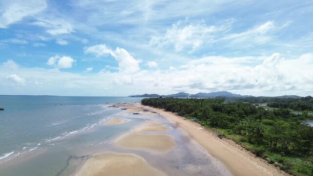 Aerial view of wide sand beach at low tide in Carles Iloilo Philippines revealing exposed seabed and expansive tropical shoreline. Calm coastal landscape in the Western Visayas region.