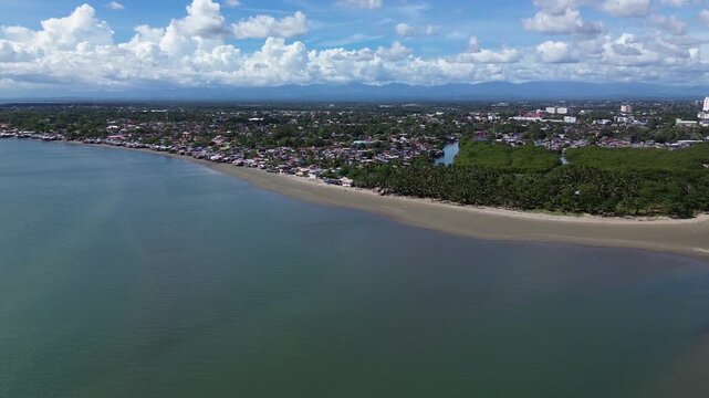 Drone aerial of Iloilo City highlighting modern skyline, residential districts, Rural Areas with River, and expanding infrastructure on Panay Island. Dynamic urban growth in the central Philippines.