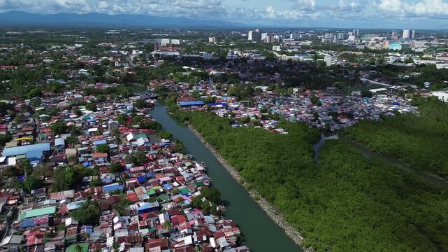 Drone aerial of Iloilo City highlighting modern skyline, residential districts, Rural Areas with River, and expanding infrastructure on Panay Island. Dynamic urban growth in the central Philippines.