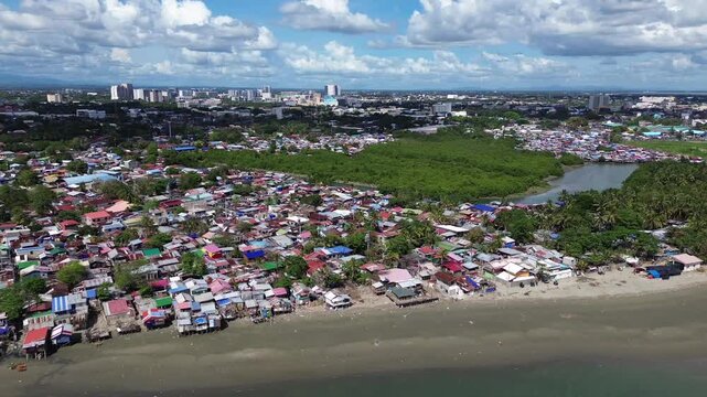 Drone aerial of Iloilo City highlighting modern skyline, residential districts, Rural Areas with River, and expanding infrastructure on Panay Island. Dynamic urban growth in the central Philippines.