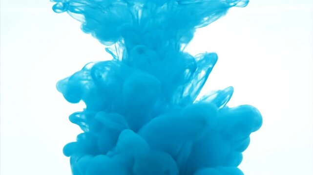 Abstract blue ink cloud expanding in clear liquid against white background