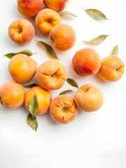 A group of peaches falling down on a white surface