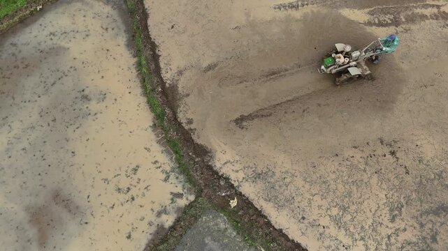Tractor Turning and Circling in Irregular Rice Paddies, Spring Morning Aerial View, China