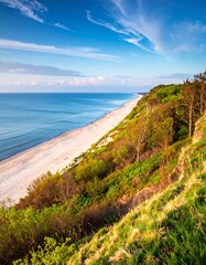 A serene coastal landscape with a sandy beach and lush greenery on a hillside