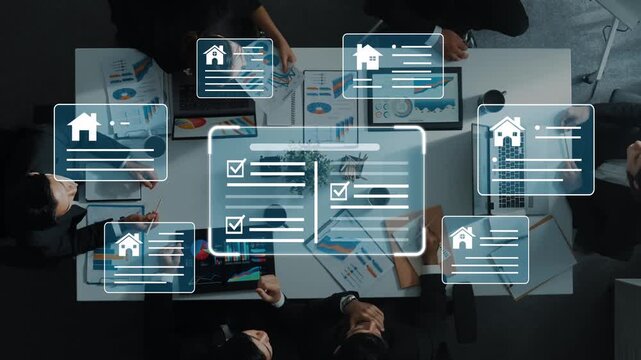 Group of Professionals Analyzing Digital Real Estate Documents and Presentations on a Conference Table with Laptops and Charts in a Modern Office Setting Gluon.