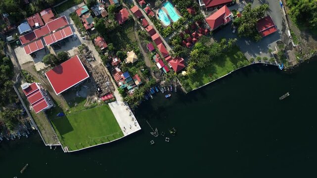 Top View shot of fishponds with houses near by at Agoncillo Laurel batangas Philippines