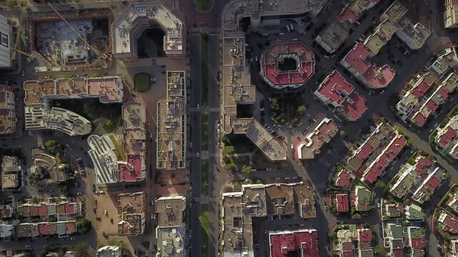 Top-down aerial drone shot showcasing the symmetrical urban planning of Hay Riad. Features luxury residential buildings, green courtyards, and organized street networks in Morocco's capital.