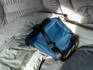 bag on unmade bed