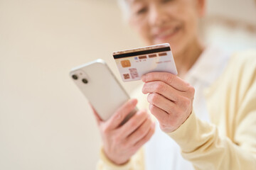 マイナンバーカードとスマホを連携するシニア女性