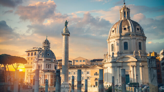 Ancient ruins of Trajan's Forum, Trajan's Column, and Baroque churches at sunset, Rome, Italy
